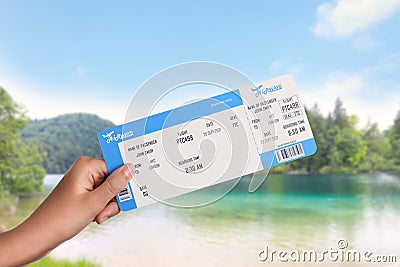Woman holding ticket near bay, closeup. Travel agency service Stock Photo