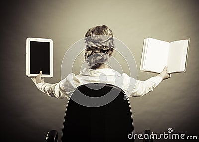 Woman holding traditional book and e-book reader Stock Photo