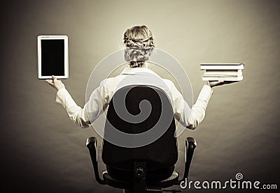 Woman holding traditional book and e-book reader Stock Photo