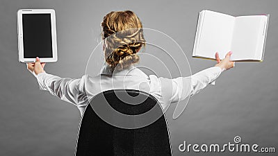 Woman holding traditional book and e-book reader Stock Photo