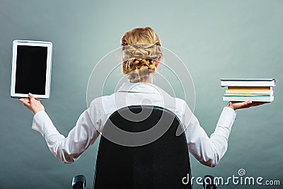 Woman holding traditional book and e-book reader Stock Photo