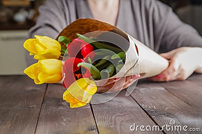 Woman holding tulips in craft paper Stock Photo