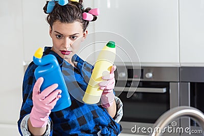 Woman holding two bottles of cleaners Stock Photo