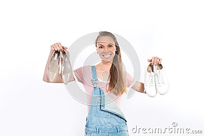 Woman holding two pairs of shoes Stock Photo