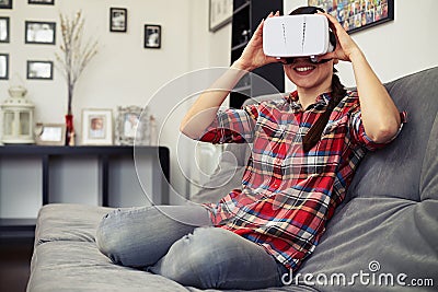 Woman holding virtual reality headset glasses and smiling Stock Photo