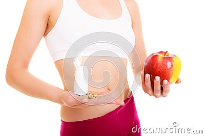 Woman holding vitamins and apple. Health care. Stock Photo