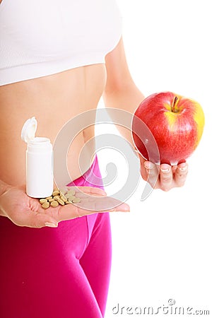 Woman holding vitamins and apple. Health care. Stock Photo