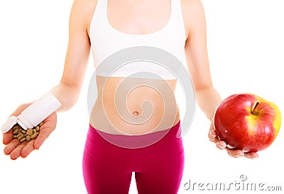 Woman holding vitamins and apple. Health care. Stock Photo