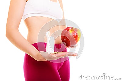 Woman holding vitamins and apple. Health care. Stock Photo