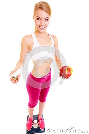 Woman holding vitamins and apple. Health care. Stock Photo