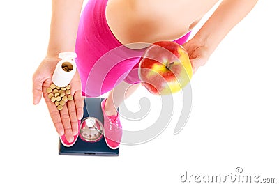 Woman holding vitamins and apple. Health care. Stock Photo