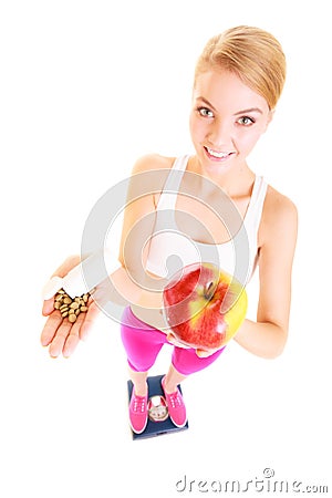 Woman holding vitamins and apple. Health care. Stock Photo