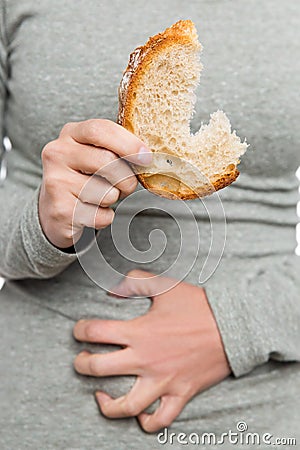 Woman holding wheat bread, celiac disease or coeliac condition Stock Photo