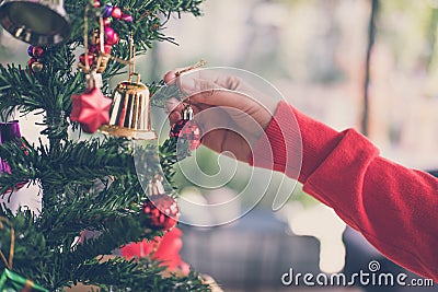 woman holding xmas ornament. girl decorate Christmas tree in a h Stock Photo