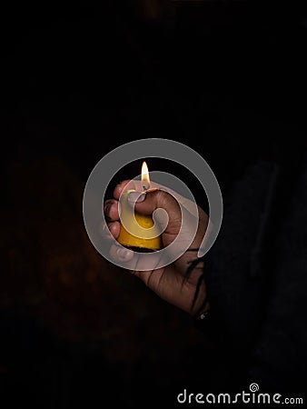 Woman holding burning candle in her hands memory grief religion faith belief in Las Lajas Sanctuary Ipiales Colombia Stock Photo