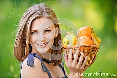 Woman holds basket with fruit Stock Photo