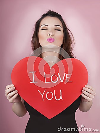 Woman holds big red heart i love you in her hands Stock Photo