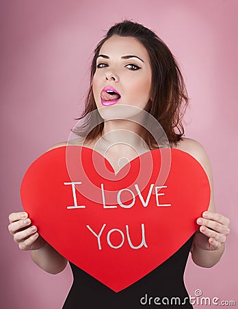 Woman holds big red heart i love you in her hands Stock Photo