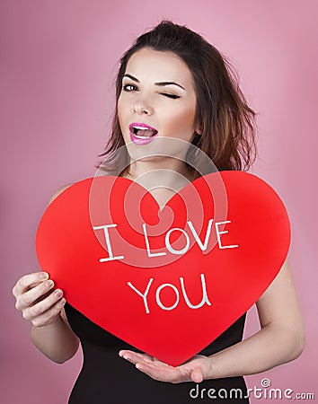 Woman holds big red heart i love you in her hands Stock Photo