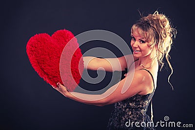 Woman holds big red heart love symbol Stock Photo