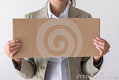 A woman holds blank sign in front her face Stock Photo