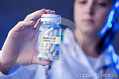 Woman holds box of antiviral medicines Stock Photo