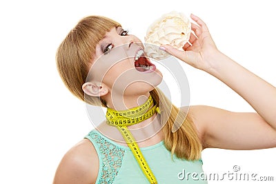 Woman holds cupcake trying to resist temptation Stock Photo