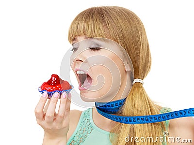 Woman holds cupcake trying to resist temptation Stock Photo