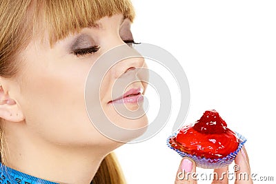 Woman holds cupcake trying to resist temptation Stock Photo