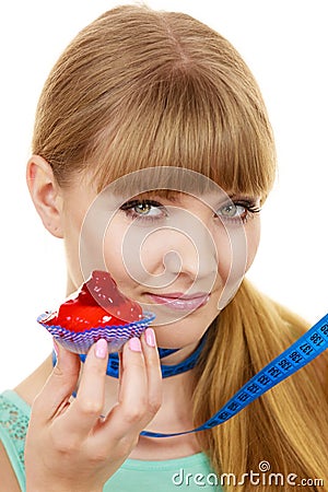 Woman holds cupcake trying to resist temptation Stock Photo