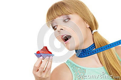 Woman holds cupcake trying to resist temptation Stock Photo