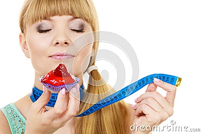 Woman holds cupcake trying to resist temptation Stock Photo