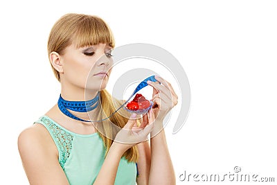 Woman holds cupcake trying to resist temptation Stock Photo