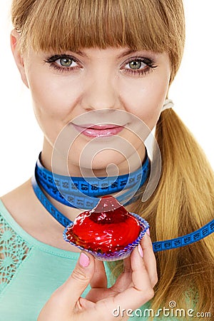 Woman holds cupcake trying to resist temptation Stock Photo