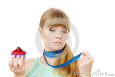 Woman holds cupcake trying to resist temptation Stock Photo