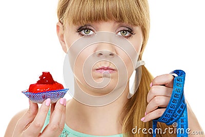 Woman holds cupcake trying to resist temptation Stock Photo