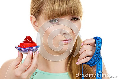 Woman holds cupcake trying to resist temptation Stock Photo