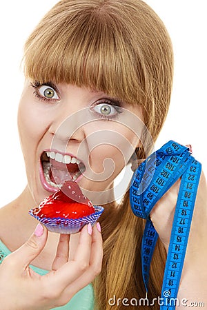 Woman holds cupcake trying to resist temptation Stock Photo