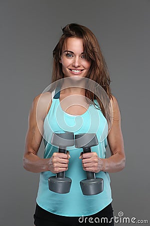 Woman holds dumbells. Stock Photo