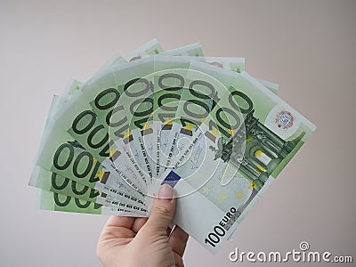 A woman holds in her hand a lot of banknotes in denominations of 100 euros fan Stock Photo