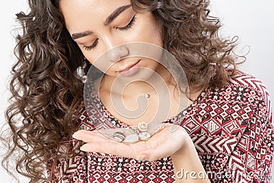 A woman holds miniature donuts in her hand and regrets that she can`t eat them Stock Photo