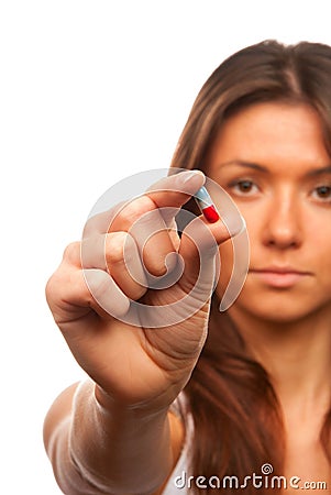 Woman holds a pill capsule in a hand Stock Photo