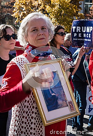 A Woman Holds a Religious Picture at a Stop the Steal Rally Editorial Stock Photo