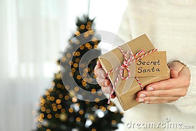 Woman holds Secret Santa gift box, space for text Stock Photo