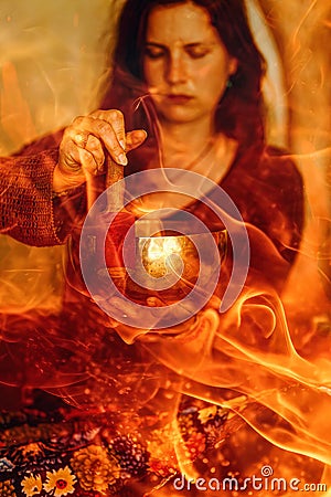 A woman holds a tibetian bowl, connecting the elemental forces of water and fire in an ethereal union, evoking Stock Photo