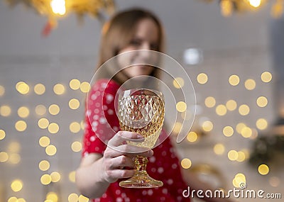 Woman at home decorated for christmas holding glass of wine and cheers close up Stock Photo