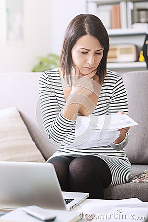 Woman checking her electricity bill Stock Photo