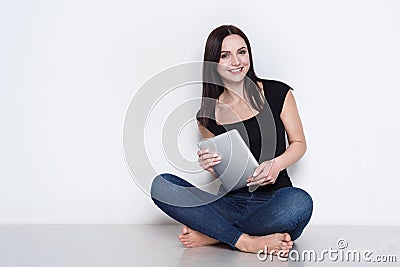 Woman at home using digital tablet, web-surfing Stock Photo