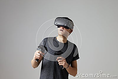 Woman At Home Wearing Virtual Reality Headset Playing Game Stock Photo