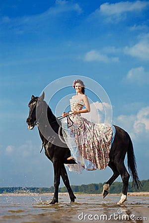 Woman on a horse by the sea Stock Photo